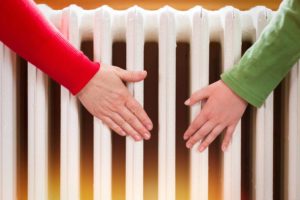 hands infront of a radiator