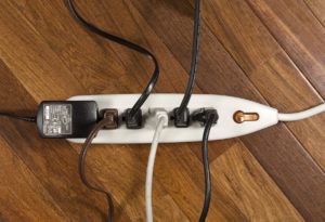 Image of power strip with many plugged in cords